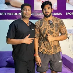 Posing with a satisfied client after his successful treatment.