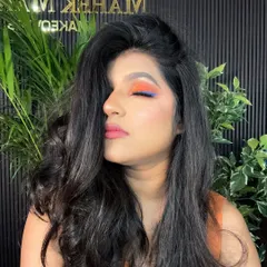 A creative and colorful eye makeup look with closed eyes. The blend of orange and blue is perfect for someone who wants to make a statement at a party.