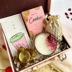 This pink leatherette trunk hamper is one of my most popular designs. It's filled with cookies, a scented candle, and a decorative diya, making it a complete festive package.
