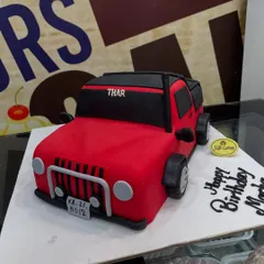 For the auto enthusiast, we crafted this 3kg cake meticulously sculpted into a vibrant red Thar jeep. Every detail, from the grille and wheels to the license plate, is handcrafted from fondant, demonstrating our skill in creating realistic 3D vehicle cakes.