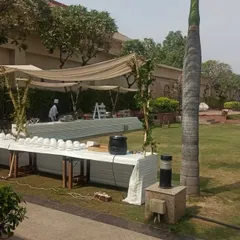 As a one-stop solution, I also manage the setup for functional areas like catering. Here is an outdoor food station with clean, white-skirted tables and a simple canopy, ensuring service is both efficient and aesthetically pleasing.