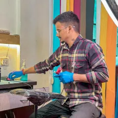 One of our talented artists, focused on setting up his station. We use sterilized, single-use equipment for every client to ensure complete safety.