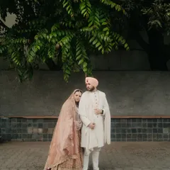 A quiet moment of togetherness. For this Anand Karaj ceremony, we chose a soft, layered pastel lehenga for the bride and a classic, understated sherwani for the groom, creating a look of serene, modern grace.
