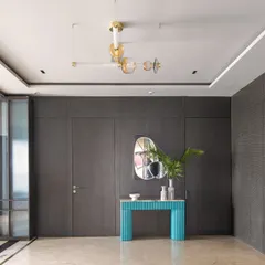 In our modern loft, we used hidden doors with a textured finish to create a sleek and sophisticated look. A bright turquoise console table provides a beautiful contrast against the dark, moody walls.