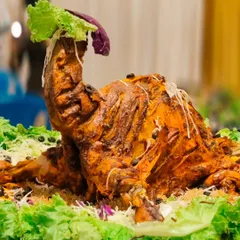 A true showstopper for any main table. This is my whole roasted chicken, marinated in special spices and cooked to perfection, ready to be the centerpiece of your wedding or party feast.