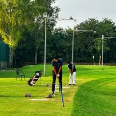 Two golfers share a bay, offering tips and encouragement. This is what our community is all about.