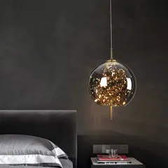 Here is one of my popular 'firefly' globe pendants installed as a bedside light. The cluster of tiny LED lights within the glass sphere creates a warm, magical glow, perfect for adding a touch of whimsy and elegance to a bedroom.