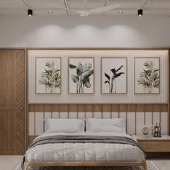 A calm and balanced bedroom featuring a paneled headboard and a series of botanical art prints. The design uses a neutral palette with wood tones to create a soothing and grounded atmosphere.