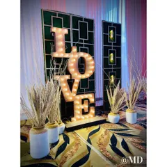 A fun and romantic photo booth option. This large, illuminated 'LOVE' sign provides the perfect backdrop for guests to capture memories.