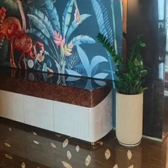The right indoor plant completes a room. Here, a low-maintenance ZZ plant in a textured ceramic pot adds a touch of green without competing with the bold interior design.