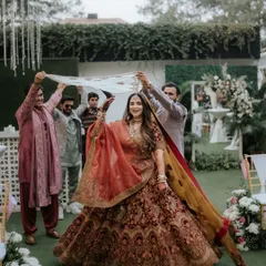 The bride makes her grand entrance under a beautiful phoolon ki chadar, held by her loved ones. This is a classic, emotional moment that I always feel honored to capture.