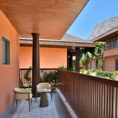 Step out onto your private balcony to enjoy a quiet morning coffee or an evening chat. The space is furnished for your comfort, offering a personal connection to the resort's serene landscape.