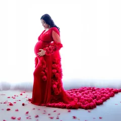 A high-impact portrait featuring a vibrant red gown with a train of roses. The high-key lighting makes the color pop, creating a truly memorable image.
