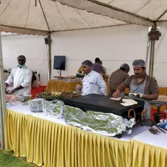 A full view of our live cooking setup at an outdoor event. This station features a tawa for fresh breads and a kadai for live stir-fries, managed by our professional chefs.