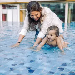 A first birthday splash. There's nothing like the delight on a child's face when they experience something new and fun, like playing in the water for the first time.