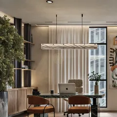 A private cabin should be both a workspace and a retreat. In this design, we used a statement green marble desk, a sculptural light fixture, and warm wood shelving to create a leadership space that feels powerful, personal, and comfortable for a long day's work.