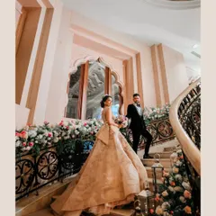 A fairytale moment on the grand staircase of The Leela Palace Bengaluru. I lined the stairs with cascading arrangements of pink and white flowers and soft lanterns to create a romantic pathway for the couple.