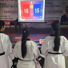 Trainees at the Rajasthan referee course analyze a match scenario on the projector screen. This practical training includes using scoring systems to ensure accuracy and consistency in judging.