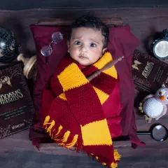 A little touch of magic for your magical new arrival. I love getting creative with themed newborn shoots, like this adorable Harry Potter setup, complete with a wand and scarf.
