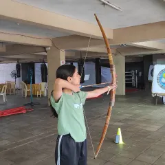 This student demonstrates great form and focus during a practice session. You can see her aligning the shot, a skill we develop over the 8-session course.