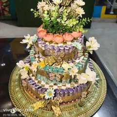 A closer look at the finished 11,000 rupee note platter, designed as a tiered cake. It's a grand way to present a cash gift for a special occasion.