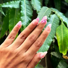A side view of the hand, showing the profile of the sculpted flower and the other textured designs in this summery set.