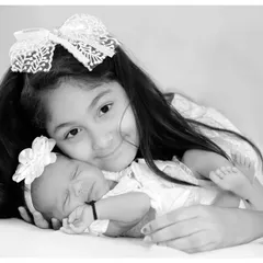 The sweet bond between siblings is one of my favorite things to photograph. This gentle moment between an older sister and her newborn sibling is a memory to cherish forever.
