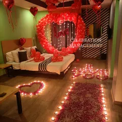 This is the ultimate romantic gesture. We filled this room with love, using a large heart-shaped balloon arch over the bed, a candle-lit pathway of rose petals, and hundreds of red balloons to create a completely immersive and passionate atmosphere.
