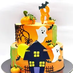 A spooky and fun Halloween-themed cake made for a birthday celebration. This two-tiered chocolate truffle cake features edible ghosts, pumpkins, bats, and a haunted house.