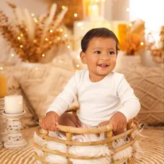 A radiant smile from this sweet baby boy in our warm, cozy boho setup. This theme is perfect for capturing simple, happy milestone portraits.