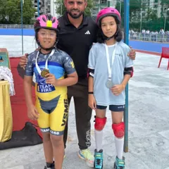 Posing with two of our medal winners from the interschool competition. Their achievements reflect the high standard of competitive roller skating coaching we offer.