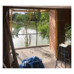 A view from the 'Keremane' lake house project during its construction phase. The design intentionally frames the natural landscape, blurring the line between the indoor living space and the lakeside environment. This highlights my commitment to creating architecture that is deeply connected to its site.