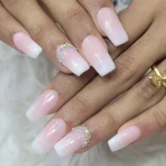 A timeless baby boomer or French ombre design, perfect for any bride. We created a seamless blend from a soft pink base to a clean white tip on these square extensions, adding a rhinestone accent for extra sparkle.