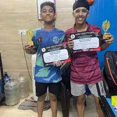Two of our academy players showing off their well-earned trophies and certificates. We believe in celebrating every achievement, big or small, on the journey of competitive badminton.
