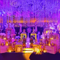 Imagine a night of pure opulence with my Great Gatsby themed bar. The combination of dramatic purple lighting, cascading fairy lights, and candle-lit lanterns creates an immersive, high-energy ambiance for your sangeet or reception.