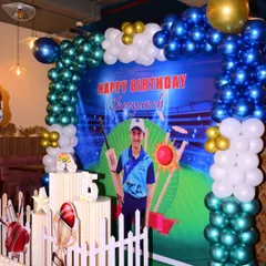 A cricket-themed birthday party is perfect for young sports fans. This decoration includes a custom photo backdrop of a stadium, a balloon arch in team colors, and cricket-related props like stumps and trophies.