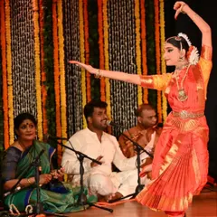 The beauty of Bharatanatyam lies in its ability to convey stories through graceful movements. Here, Kavya Navani performs during her arangetram, her form perfectly complemented by the live music ensemble.