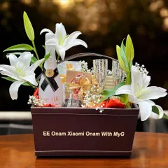 This is a luxury corporate hamper I created for Xiaomi's Onam celebration, presented in a custom-branded leatherette basket with fresh lilies, champagne, and other premium goodies.