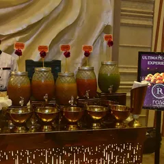 A full view of our "Ultimate Chaat Experience" counter, complete with a chef and various flavored waters for pani puri. We blend the vibrant essence of street food with refined elegance for every event.