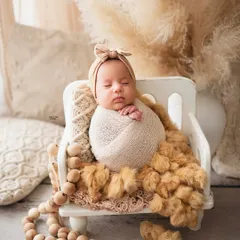 There is nothing more precious than a sleeping newborn. I specialize in creating these peaceful, dreamy portraits, ensuring your baby is safe, comfortable, and beautifully captured. This boho-themed setup with soft, neutral tones and natural textures is perfect for timeless newborn photos.