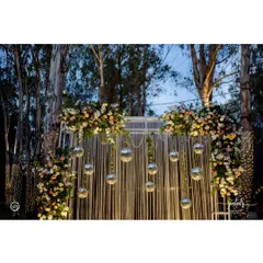 This stunning photo booth for a Sangeet night features a backdrop of white strings, hanging disco balls, and lush floral arrangements. It’s the perfect spot for guests to capture glamorous memories.