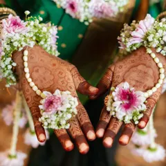 The beautiful, dark stain of a baby shower mehendi, adorned with fresh flower jewelry. This design is filled with blessings for the mom-to-be and her little one.
