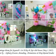 A tropical flamingo theme for Jayansh's first birthday at an apartment clubhouse. The setup features a double semi-arch backdrop, pink and teal balloons, and flamingo cutouts, bringing a touch of the tropics indoors.