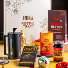 A Barista "Festive Treat" coffee-themed gift box, including a French press, coffee beans, and chocolates, styled for Diwali.