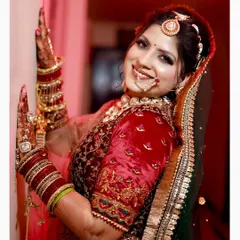 A classic bridal portrait showcasing the bride's joyful smile and intricate wedding attire. We focus on capturing the happiness and radiance of the bride on her wedding day with clean, vibrant photography.