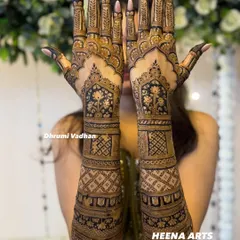 This bride wanted a grand and opulent design. I created this full-coverage mehendi with intricate floral windows, geometric jaal patterns, and delicate leafy vines on the fingers.