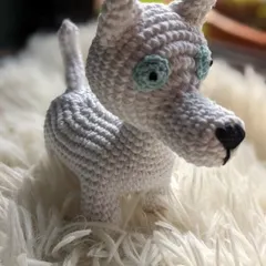 This custom crochet dog, Chase, was made to look like a white husky with light blue eyes.