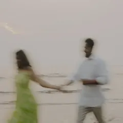 A dreamy, motion-blur photograph capturing the feeling of being swept away by love. This artistic shot from a beach pre-wedding session adds a touch of abstract beauty to your gallery.
