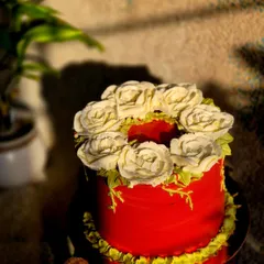 This sunset-hued beauty is crowned with a wreath of hand-piped buttercream flowers. It's a slice of edible art that's almost too pretty to cut.