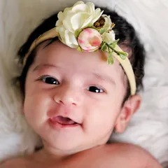 A beautiful, happy baby with bright, curious eyes. I work to make babies feel comfortable and engaged, which is how I capture such sweet, interactive portraits.
